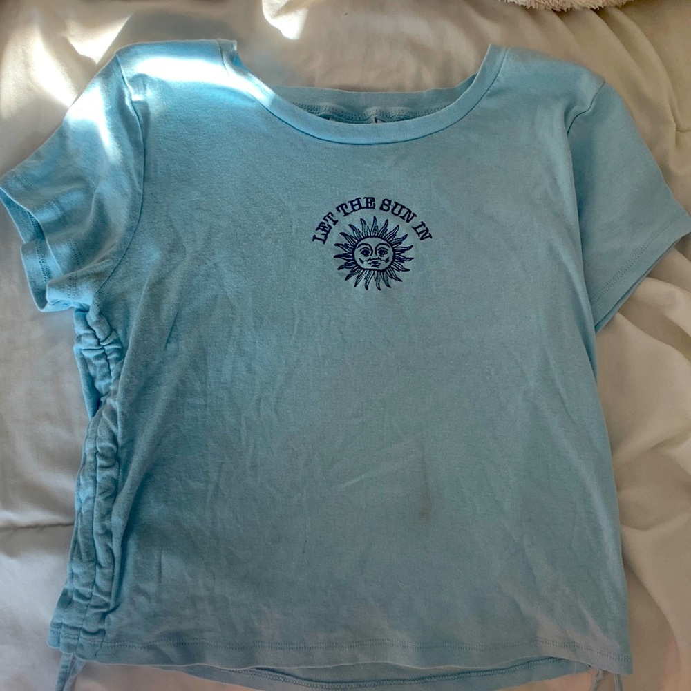Blue shirt “let the sun in “ quote.